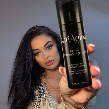 Woman holding a black bottle of Onyx Anti-Ageing cream towards the camera with a neutral background
