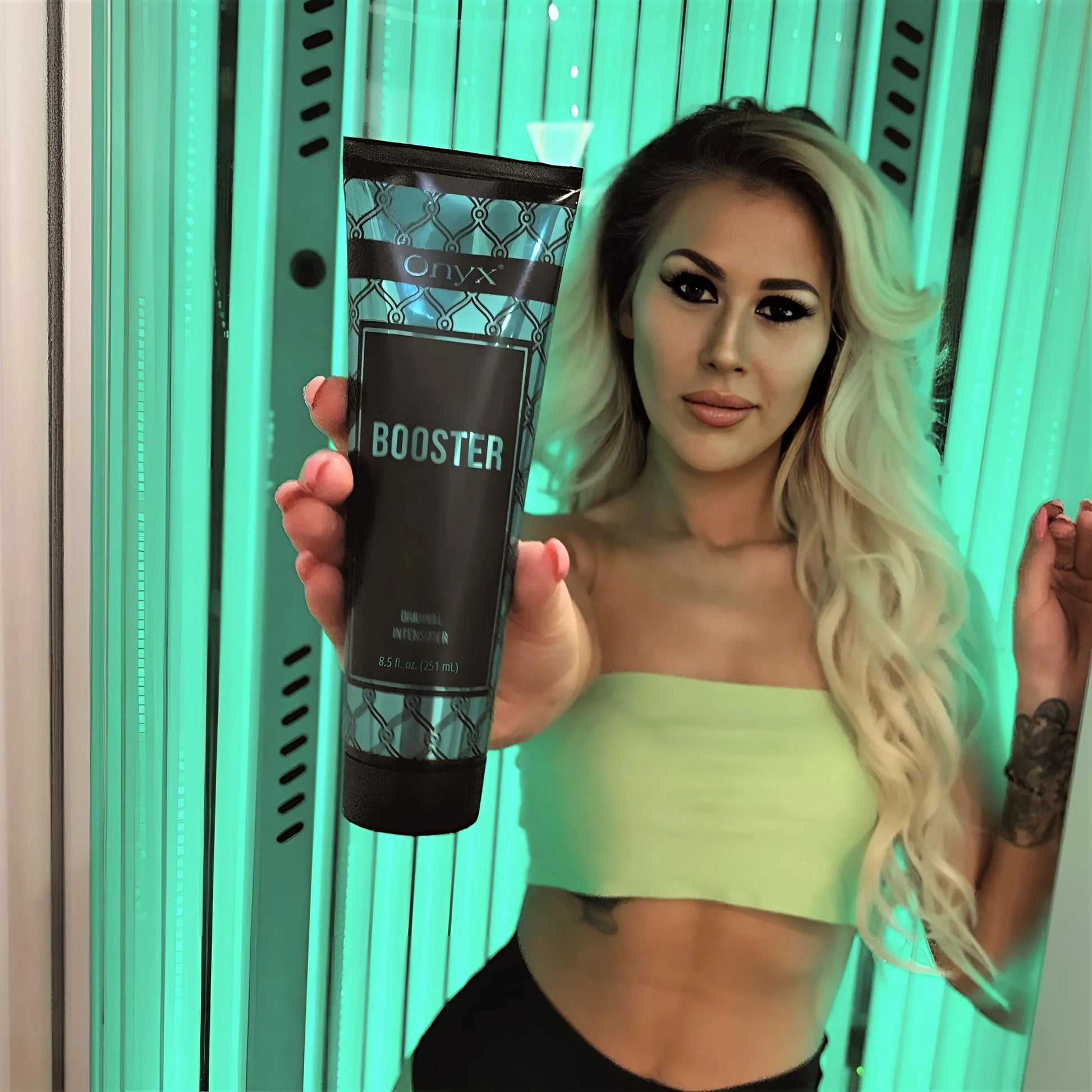 Onyx Booster accelerating cream shown during sunbed tanning session in vertical booth